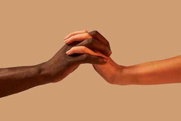 Unrecognizable multiracial couple holding hands