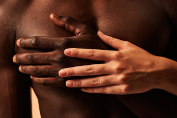 Crop couple touching hands in studio