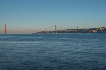 Tagus River (Rio Tejo) with 25 de Abril Bridge and Sanctuary of Christ the King on background  - Lisbon, Portugal