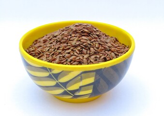 Flax seeds in a bowl on white background 