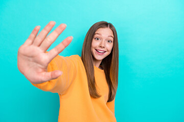 Photo cadre of young excited teen girl wear orange sweatshirt giving five number perfect mark...