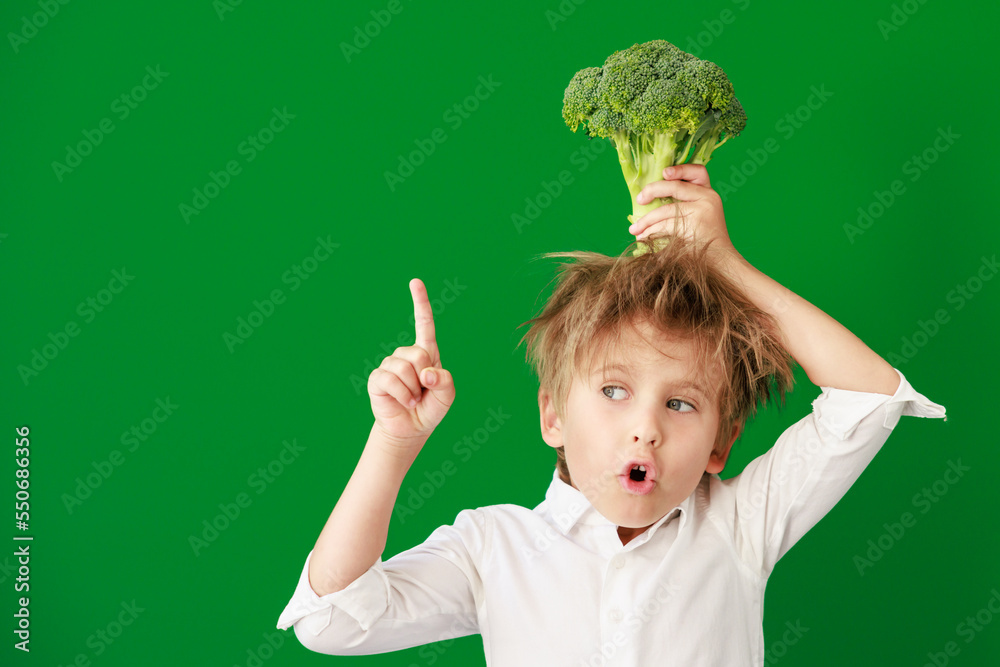 Wall mural Surprised child against green chalkboard in class