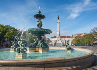 Fototapeta na wymiar Fountain and Dom Pedro IV Monument at Rossio Square - Lisbon, Portugal