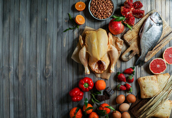 Allergy food concept. allergene - fish, chicken, strawberry, bread, wheat, sweet red pepper, eggs, peanuts, citrus, wheat flower and others on wooden table, top view