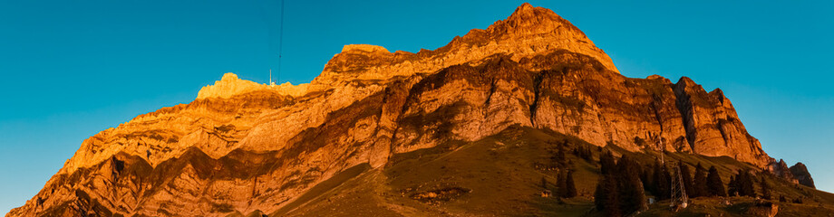 High resolution stitched sunset panorama with alpine glow and the famous Saentis summit, Schwaegalp, Appenzell, Alpstein, Switzerland