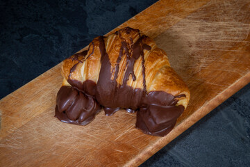 Chocolate stuffed croissant bread on rustic wood table