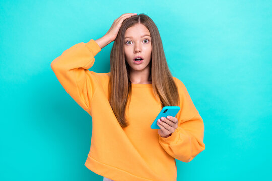 Photo of young funny stressed nervous little girl touch head forgot her email password new smartphone isolated on aquamarine color background