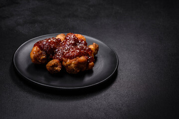 Tasty spicy chicken legs with teriyaki sauce and sesame seeds