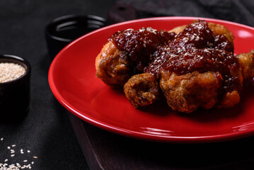 Tasty spicy chicken legs with teriyaki sauce and sesame seeds