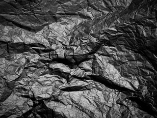 Crumpled black paper with texture. Dark black textured background