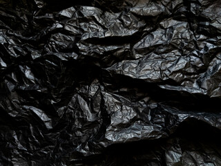 Crumpled black paper with texture. Dark black textured background