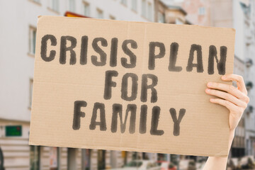 The phrase " Crisis plan for family " is on a banner in men's hands with blurred background. Trouble. Failure. Income. Risk. Saving. Solution. Stress. Bad. Bill. Bankrupt. Analysis. Budget. Coin
