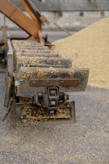 Wheat, after harvest. Whole grain for flour products. Automatic food loading. Modern grain loader and separator of agricultural machinery, agricultural machine working with crop
grain grinder at work