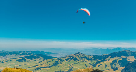 Beautiful alpine summer view with a paraglider at the famous Ebenalp, Appenzell, Alpstein, Switzerland