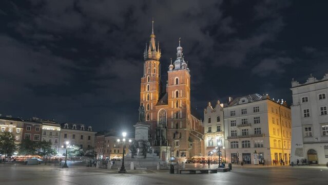 NIght Krakow time-lapse. Main Market Square. Saint Mary&rsquo;s Basilica and Adam Mickiewicz Monument in Krak&oacute;w. Clouds move quickly across the night sky. Krak&oacute;w Old Town.