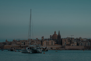 Cityscape of Valletta, Malta on an autumn evening in golden hour or blue hour. Nice panorama with still water and no lights in the city.