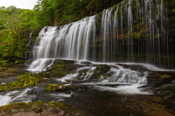 Fototapeta na wymiar Big waterfall in the forest. Long expousure