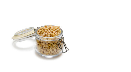 Full jar of pine nuts on a white background. copy space