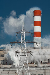 The pipe of the industrial plant emits toxic smoke into the atmosphere and air. Pollution of the environment and ecology. Thermal power plant power lines high voltage