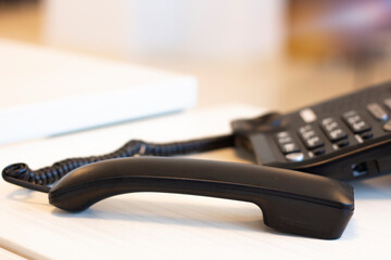 Black open phone on office desk.  Communication technology concept.