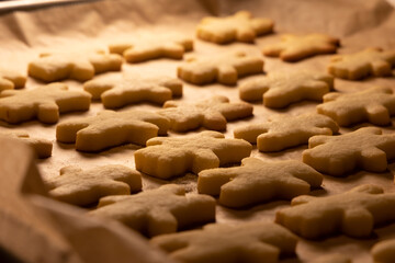 baking christmas cookies - closeup view over a pan of fresh baked homemade christmas cookies,...