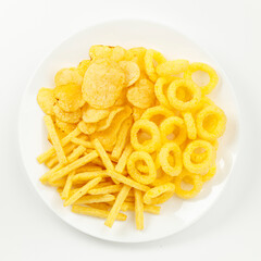 Set of corn snacks and potato chips on a white background.