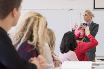 Female  teacher or professor  giving a lecture in a classroom