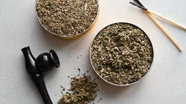 Tobacco free alternative, herbal and flower mixes with smoking wooden pipe, smoking herbal blends. Top view.