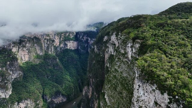 Aerial view of the majestic Canyon del Sumidero in Mexico. Flight over the canyon in the clouds.