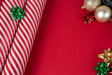 Red christmas background with red and white wrapping paper, balls and bows with copy space, top...