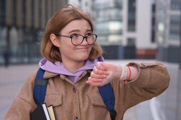 Stressed anxious young girl, woman is late busy university or college student with books, textbooks...