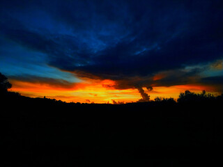 Red-orange sunset with blue-toned clouds