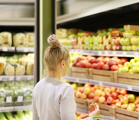 Woman buying fruits and vegetables at the market