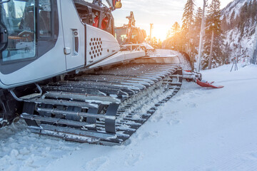 Parking on a slope snow removal equipment for a ski resort. Snow plowing bulldozer grooming for...