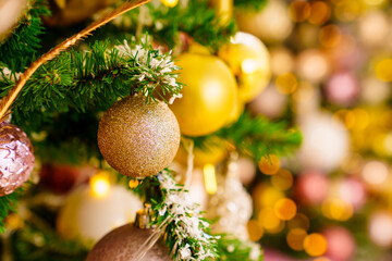 A part of Christmas tree with gold decor in a classic style.