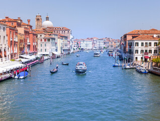 Fototapeta na wymiar View of Grand Canal and Basilica Santa Maria della Salute in Venice. View of Venice Grand Canal in a sunny summer day.