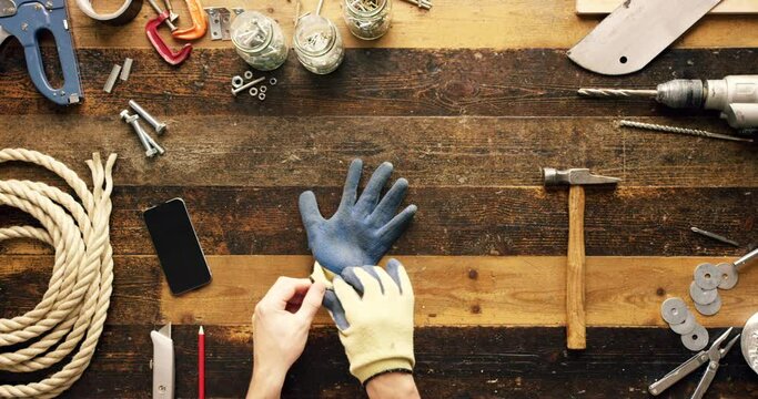 Hardware tools, table and hands of man, working as handyman, carpenter or construction worker doing a DIY project. Engineer in workshop for trade, carpentry or maintenance for a renovation mockup