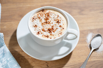 Cup of coffee on table on grey background