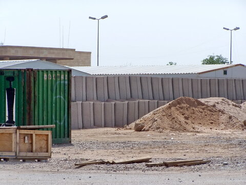 Blast barriers along a road on a British Forward Operating Base in Basra, Iraq, during Operation Iraqi Freedom