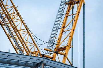 Industrial construction crane against a cloudy sky. Auckland.