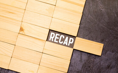 Recap word from wooden blocks on desk.