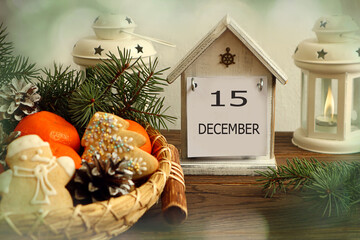 Calendar for December 15: decorative house with the name of the month of December, the number 15,...