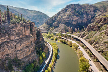 Interstate 70 (I-70) and a train beside the Colorado River in the Rocky Mountains of Colorado in...