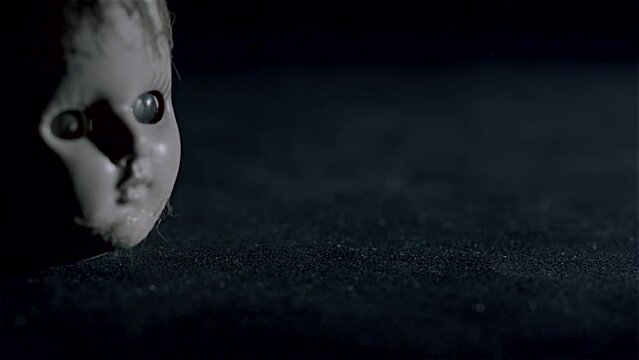 CREEPY LITTLE DOLL HEAD HITS THE GROUND AND LANDS UPRIGHT.  180 FPS, FULL HD.