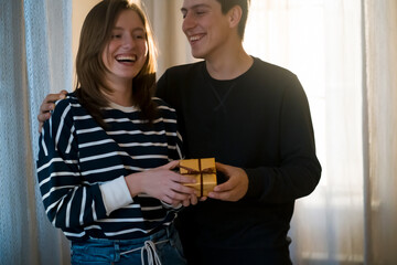 Young girl and man present gifts to each other.