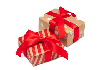 Close up set of two gift boxes wrapped in striped and dotted craft paper and decorated with satin...