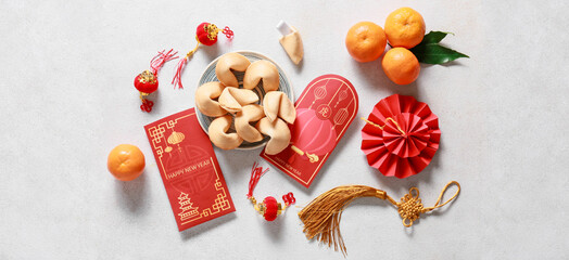 Fototapeta na wymiar Red envelopes with Chinese symbols on light background, top view