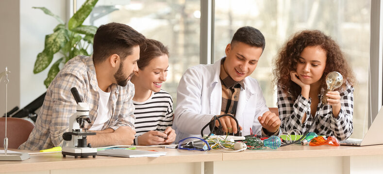 Young students and teacher at physics lesson in classroom