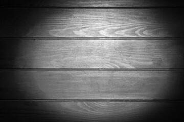 Backlight on black wooden texture as background