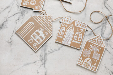 Christmas cardboard houses with rope on light background